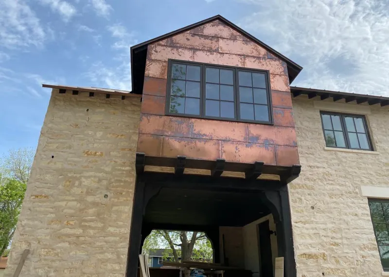 Copper metal panel facade on a stone building for Skylight Installation in League City