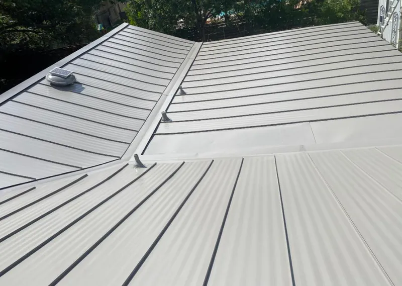 Solar attic fan installed on a metal roof for Roof Ventilation in League City